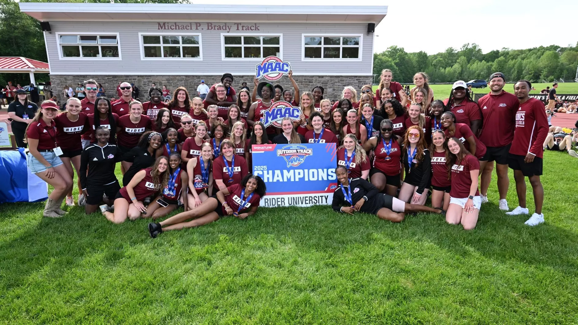Women's Track and Field team posing after MAAC Championship Win