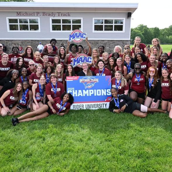 Women's Track and Field team posing after MAAC Championship Win