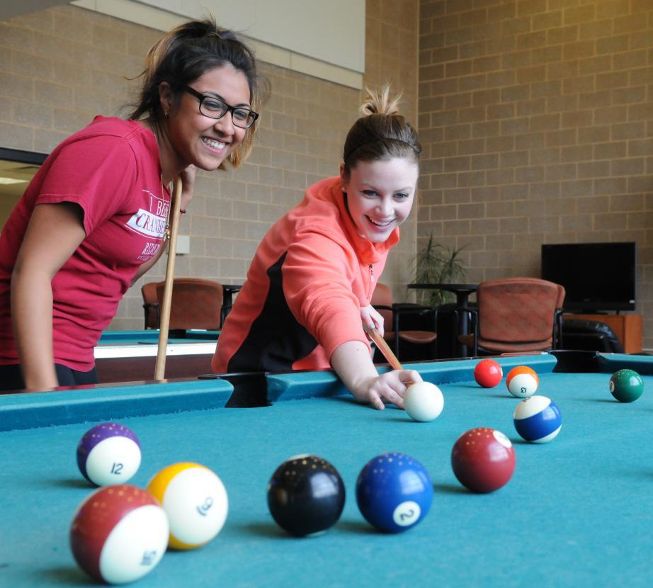 students playing pool in commuter lounge