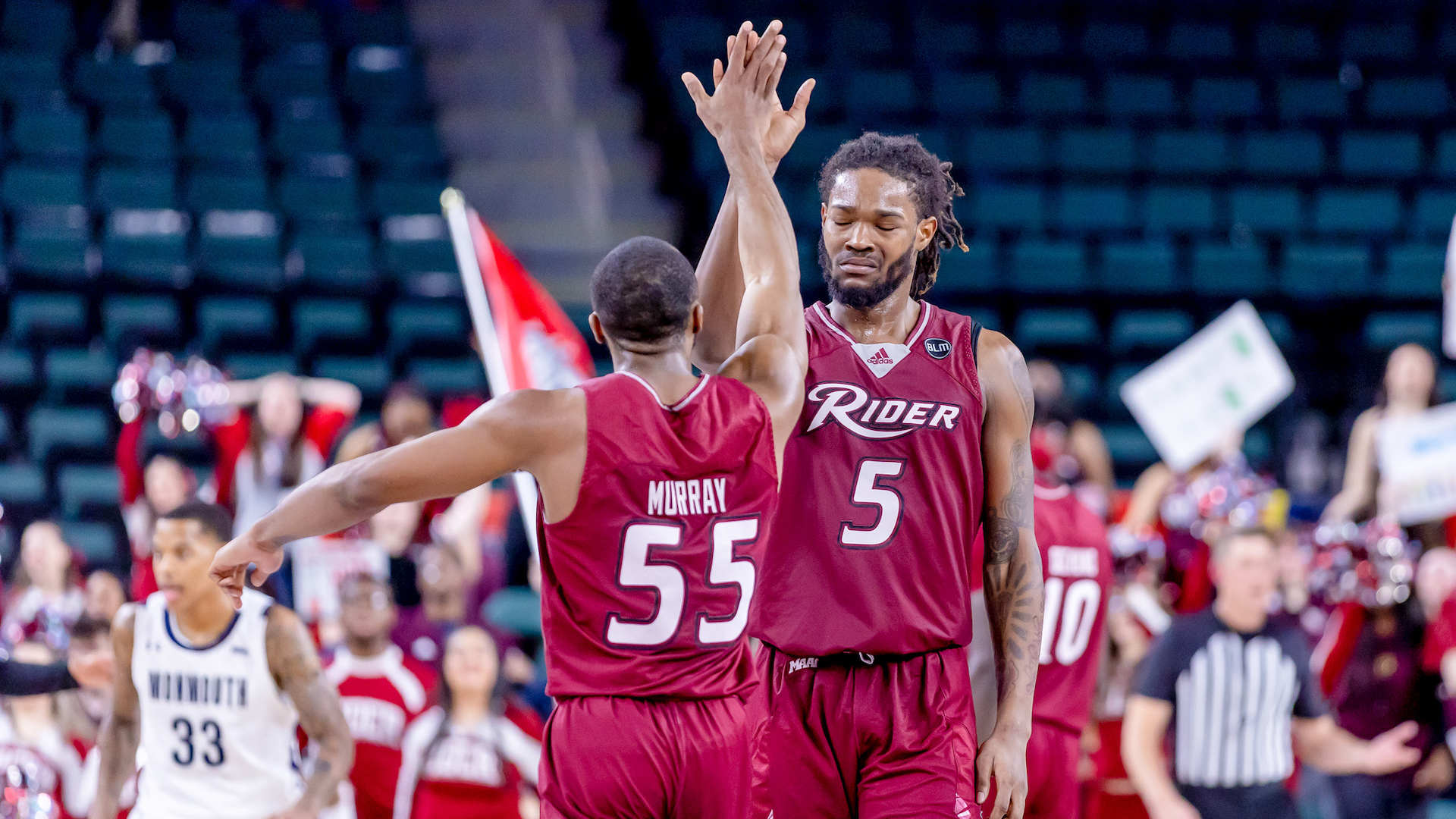 Basketball players high five at game