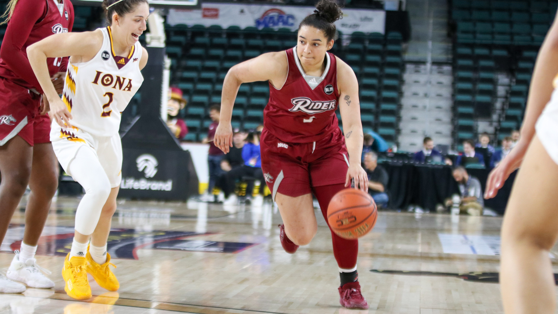 Basketball player dribbles ball at game