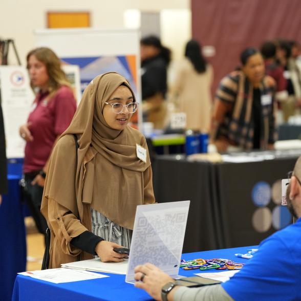 A student meets with an employer at the career fair.