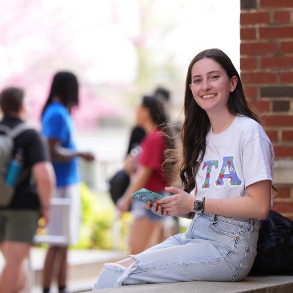 Student facing camera, on campus